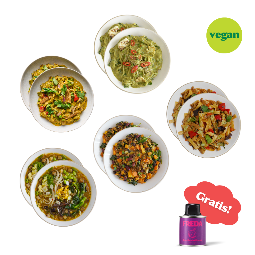 Verschiedene vegane Gerichte in Schalen, daneben eine kleine Dose mit der Aufschrift "FREDA", und ein grünes vegan-Logo.