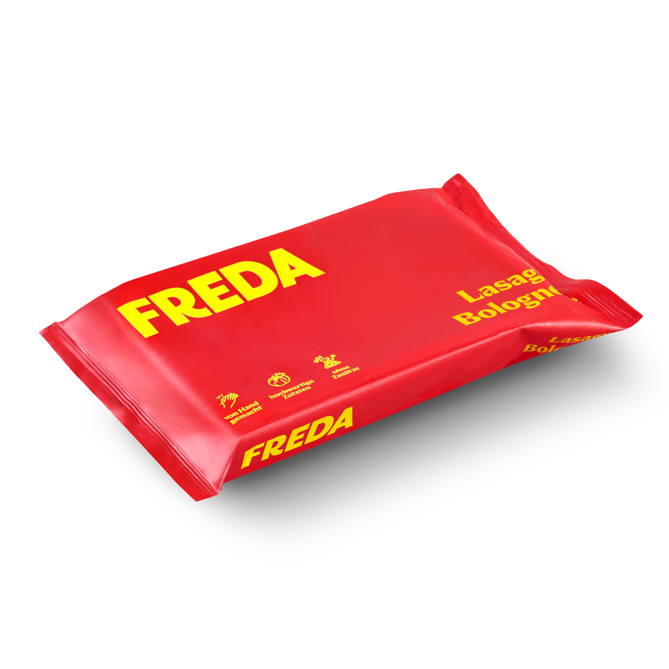 Rote Verpackung mit gelber Aufschrift "FREDA" und "Lasagna Bolognese" auf schwarzem Hintergrund.