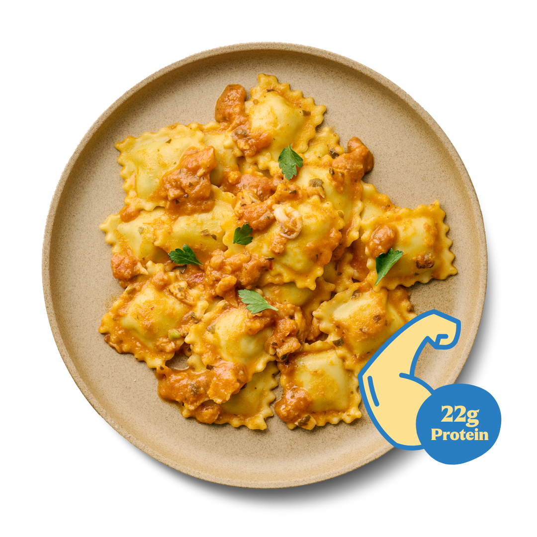 Teller mit Ravioli in Tomatensauce, garniert mit Petersilie. Ein Symbol zeigt "22g Protein" an.
