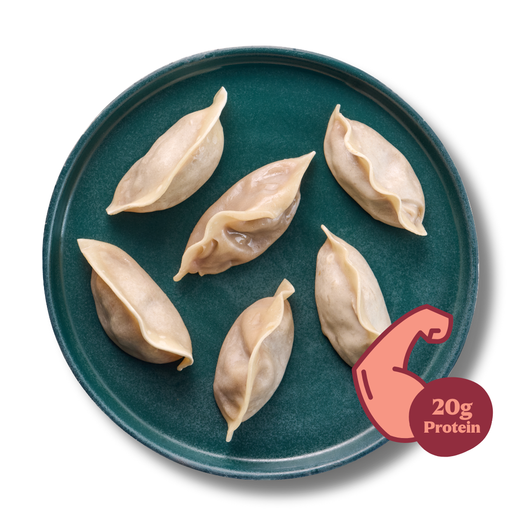 Sechs Dumplings auf einem grünen Teller mit einem Symbol für 20g Protein.